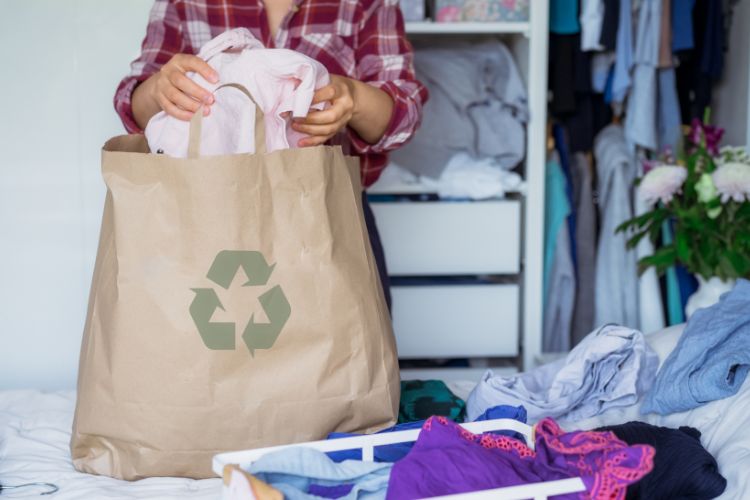 Sorting clothing out into a bag when clearing out space