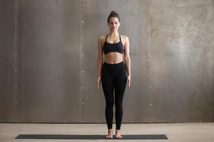 Woman standing in mountain pose on a yoga mat