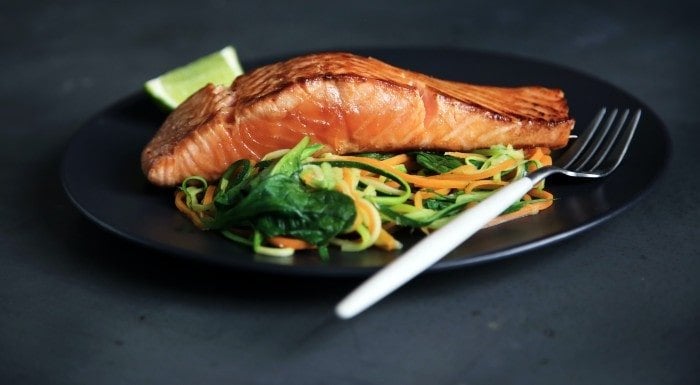 Salmon fillet on a bed of spinach and vegetable noodles