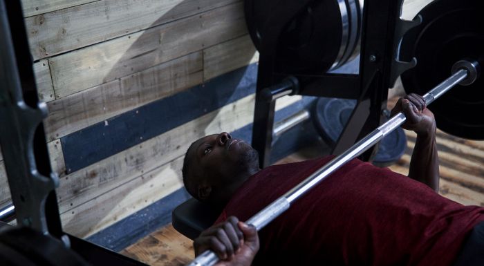 Man doing a barbell bench press in the gym