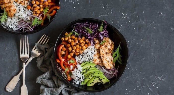 Salad bowls with chickpeas, grilled chicken, avocado and red cabbage
