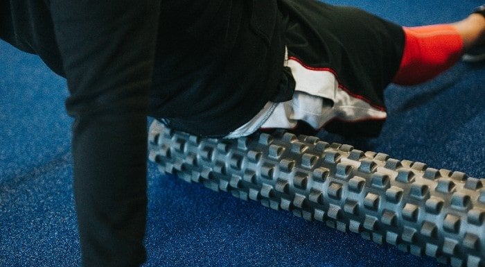 Person using a foam roller on their leg