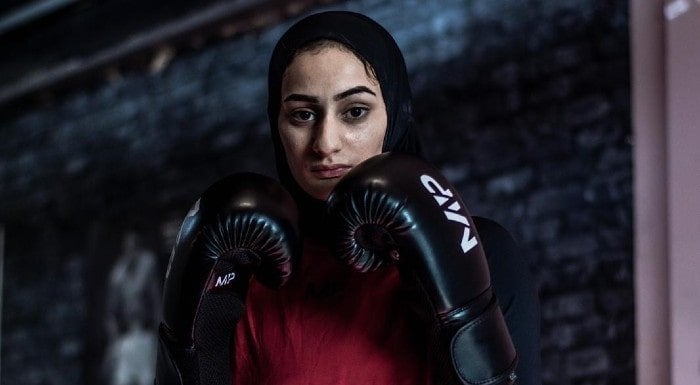 Boxer Saf in a hijab and boxing gloves, in a guard stance