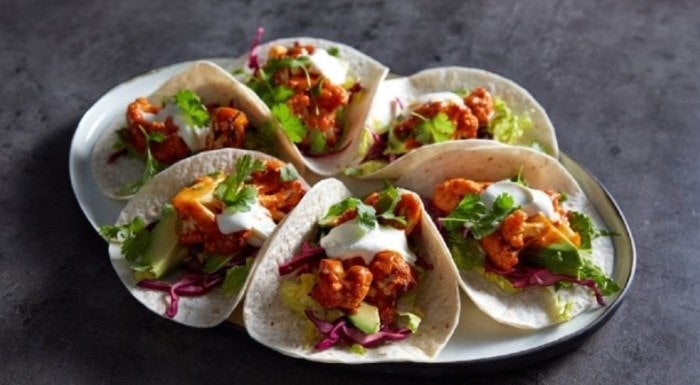Vegan buffalo cauliflower tacos on a plate