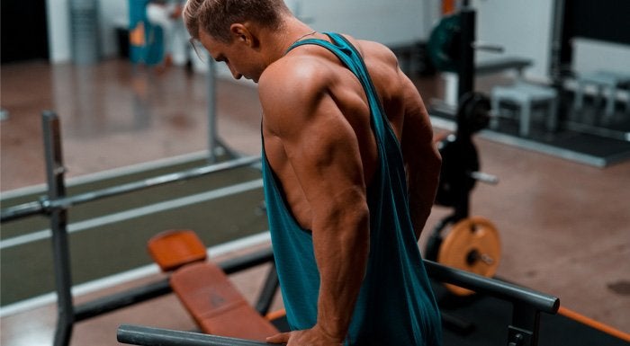 Man doing dips on parallel bars in the gym