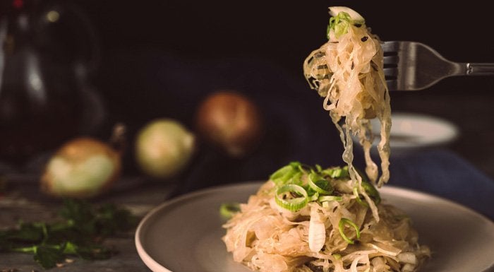 Forkful of sauerkraut over a plate