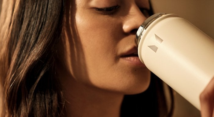 Woman drinking from a Myprotein shaker