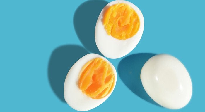 Halved boiled eggs on a blue background