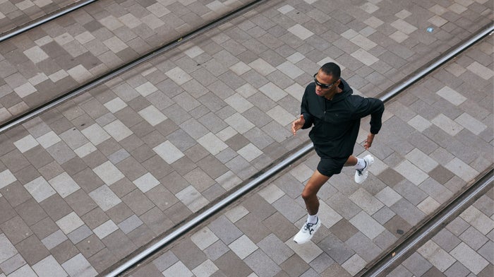 Man running across a paved square, seen from above