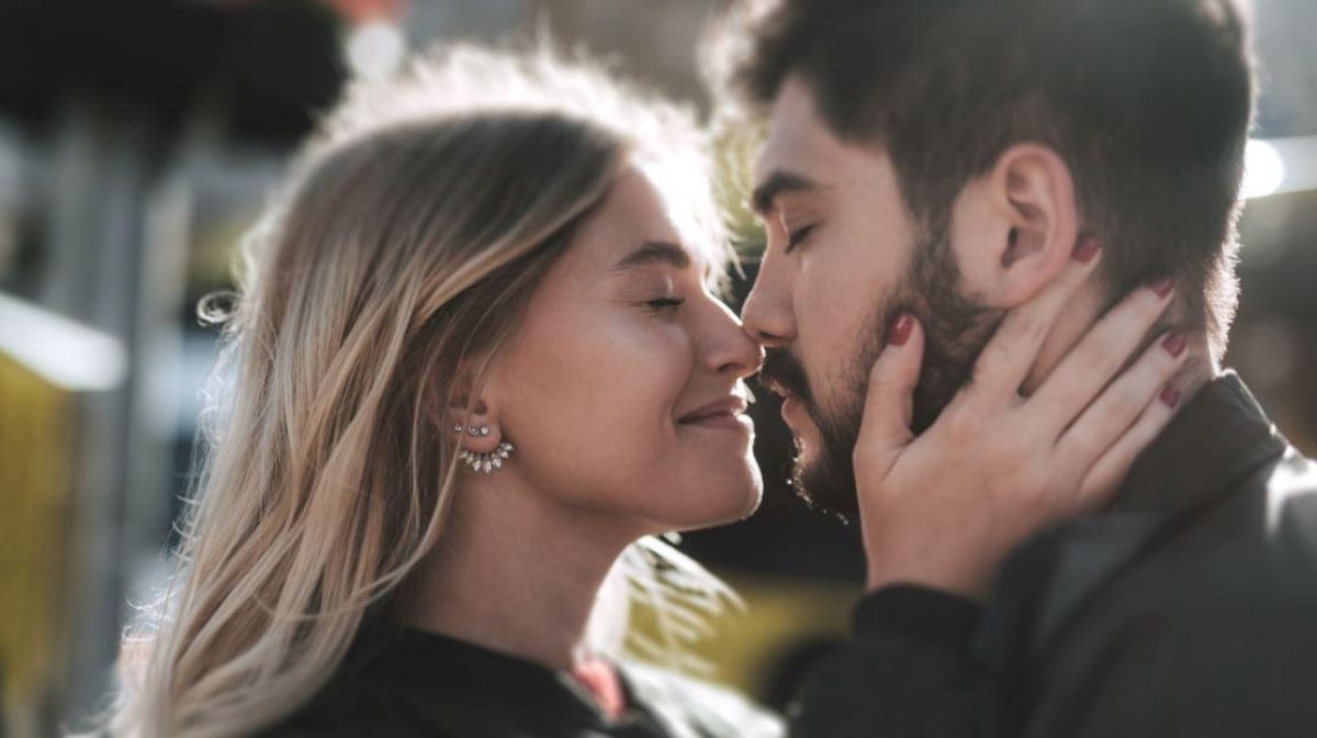 woman smelling man's beard