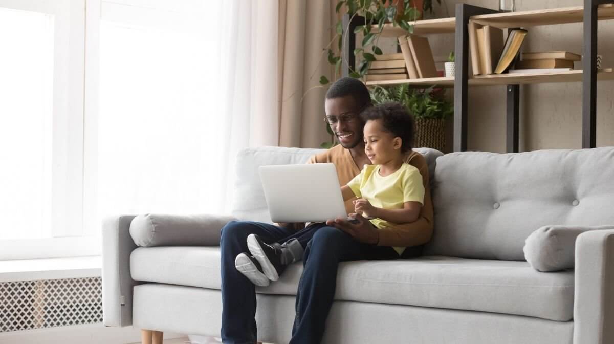 A father and son enjoying sofa tourism | Gillette UK