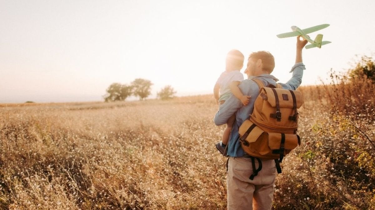 A dad and son enjoying time in nature with a model airplane | Gillette UK