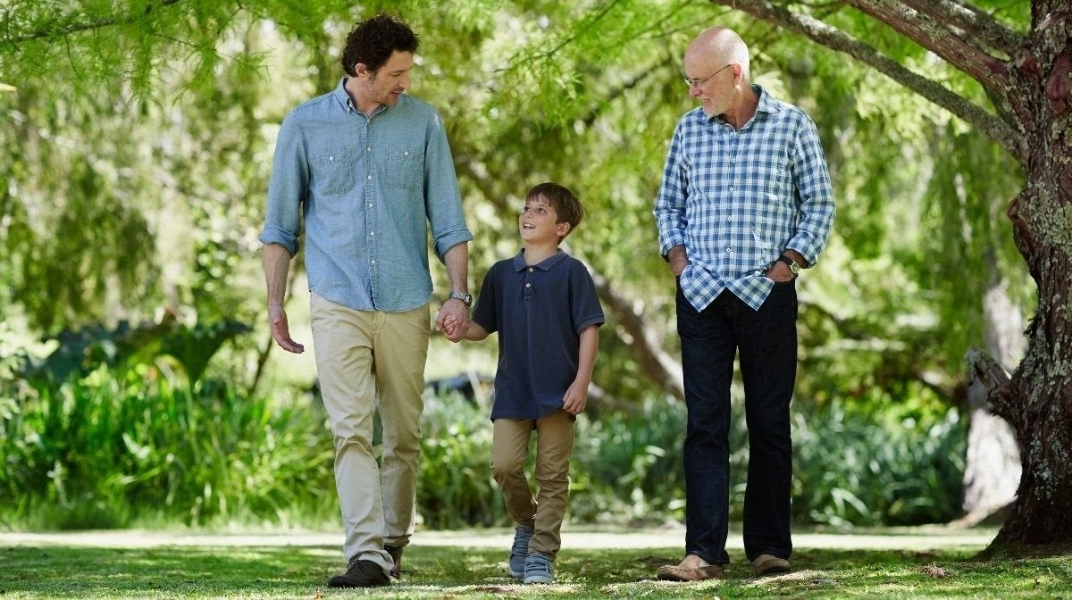 three generations - grandfather, father and son - walk through woodlands | Gillette UK