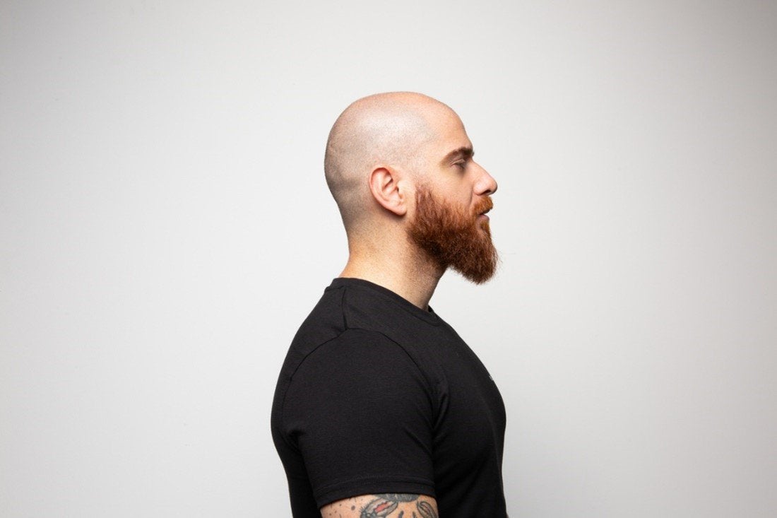 Side profile of a bald man with a medium beard style | Gillette UK