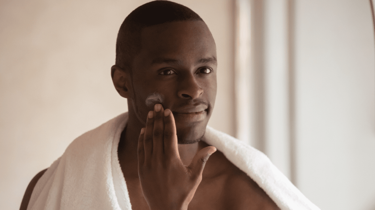 Man applying skincare products after shaving routine