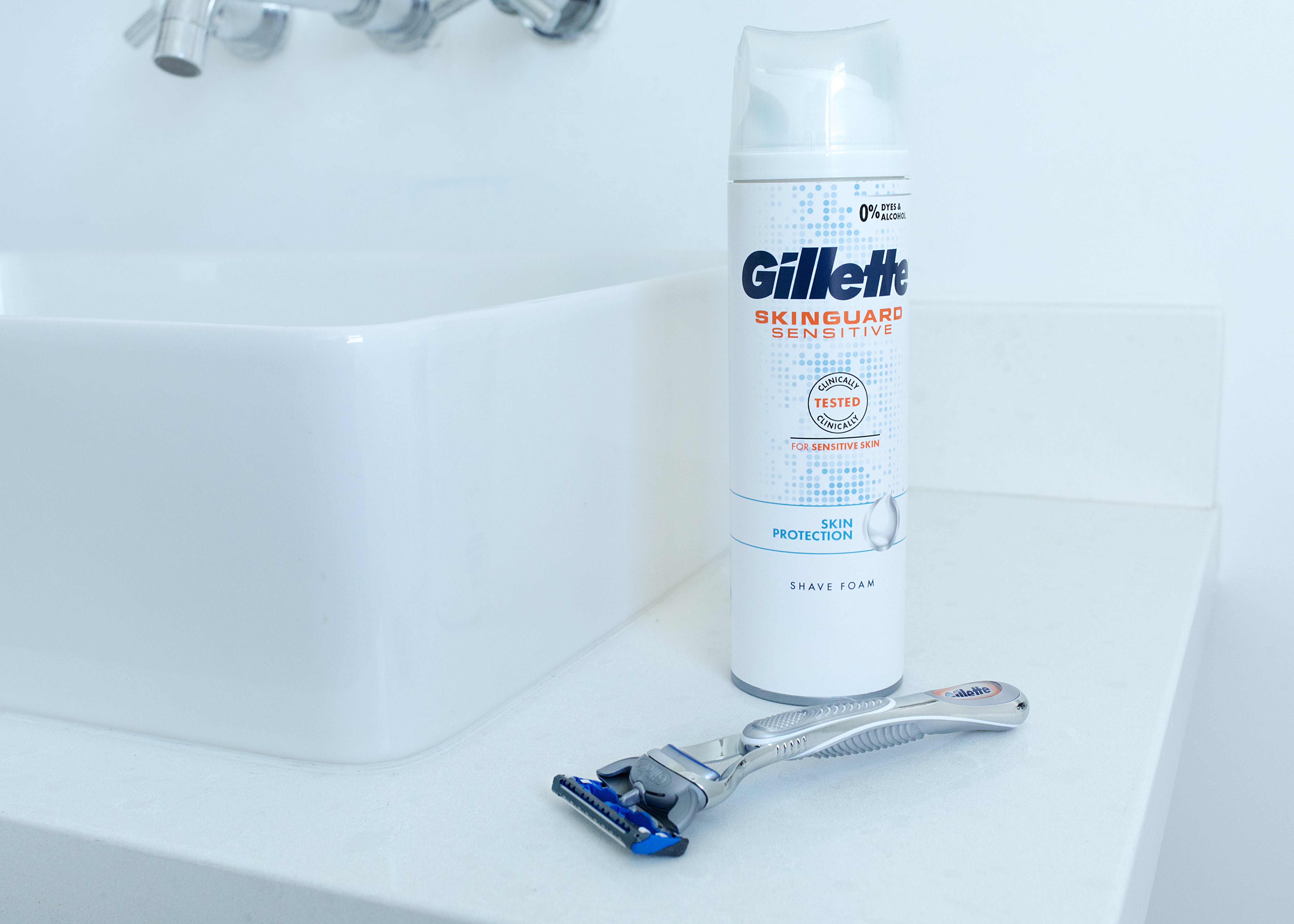 Gillette Skinguard Sensitive Shaving Foam and razor at the side of a sink | Gillette UK