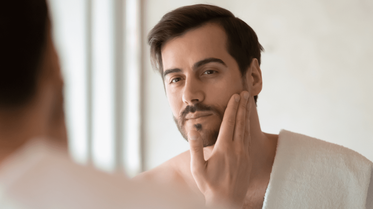 A man with a goatee, touches his face | Gillette UK