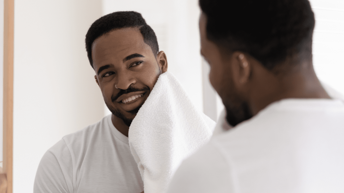 A man gently pats his face with a clean white towel | Gillette UK