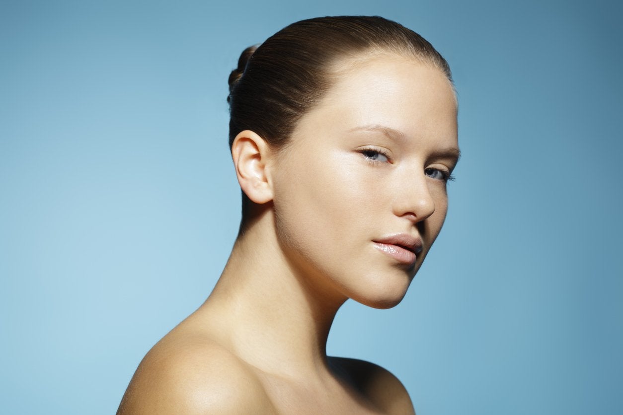 Portrait of woman with clear skin on a blue background | Gillette Venus UK