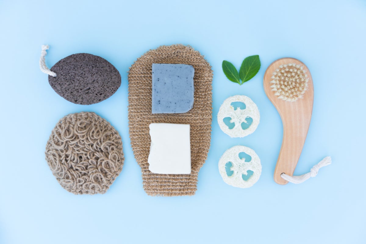 Natural exfoliating tools and soap against a pale blue background | Gillette Venus UK