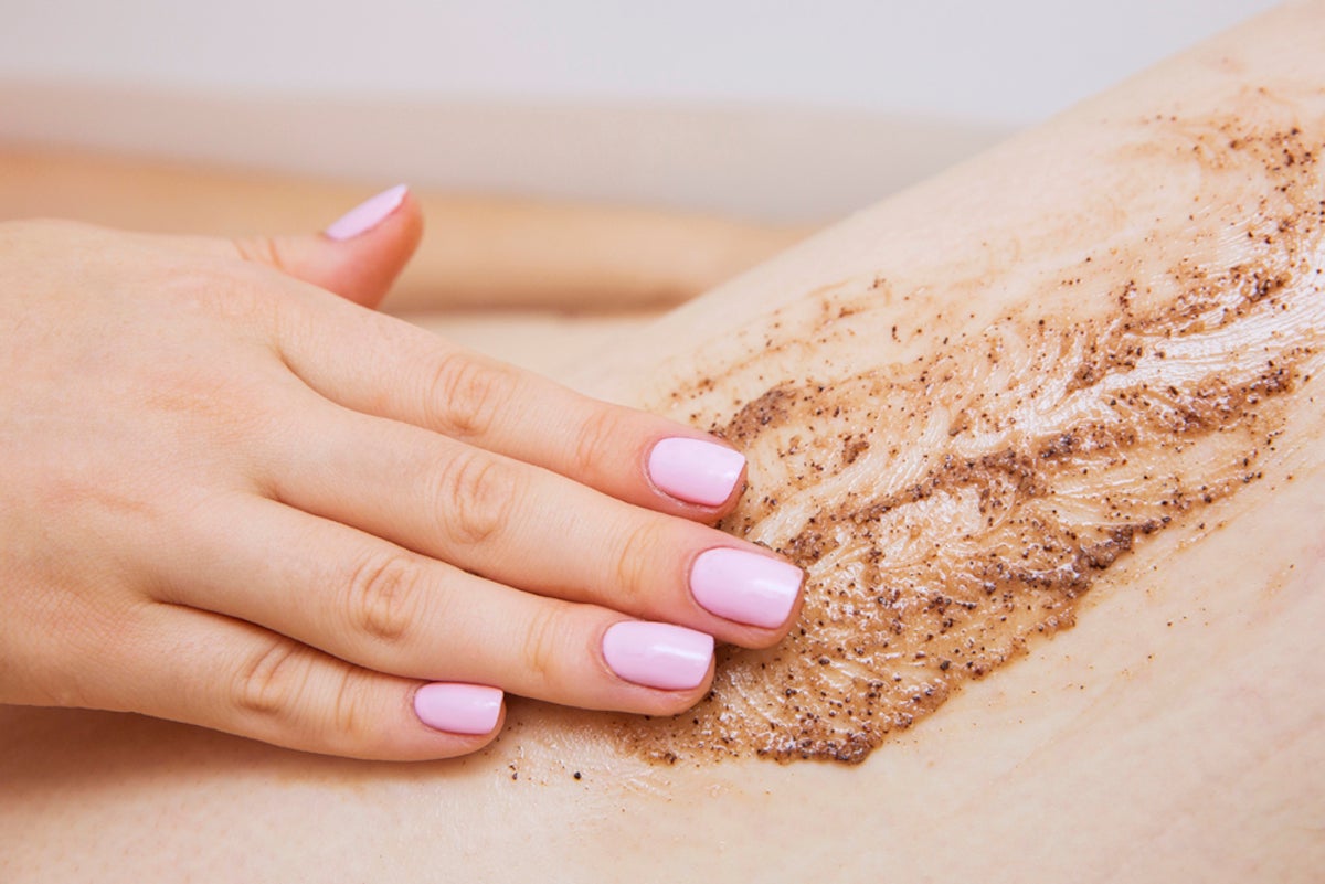 A woman exfoliates her leg wit a scrub | Gillette Venus UK