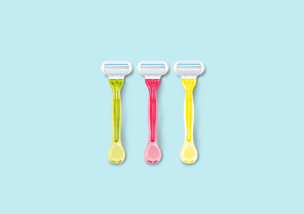 Green, pink and yellow Gillette Venus razors against a pale blue background | Gillette Venus UK
