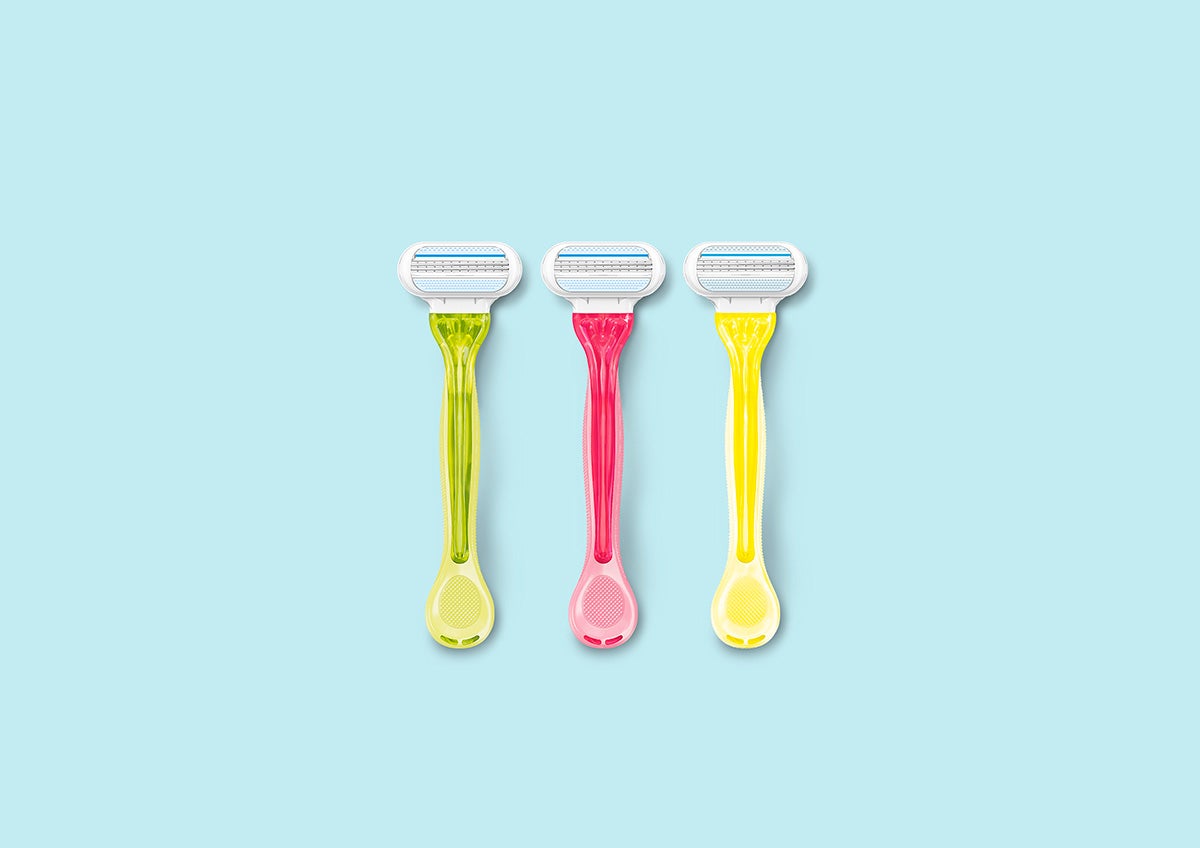 Green, pink and yellow Gillette Venus razors against a pale blue background | Gillette Venus UK